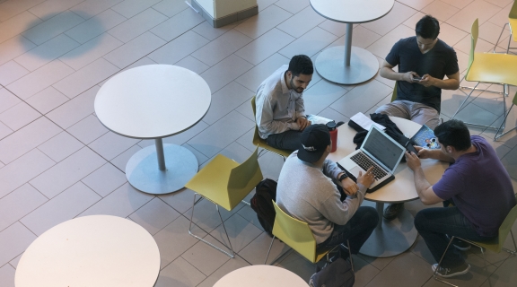 Aerial shot of students around a table